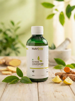 Nutravia Active Compound bottle on a wooden surface with ginger, lemon, and green leaves in the background.