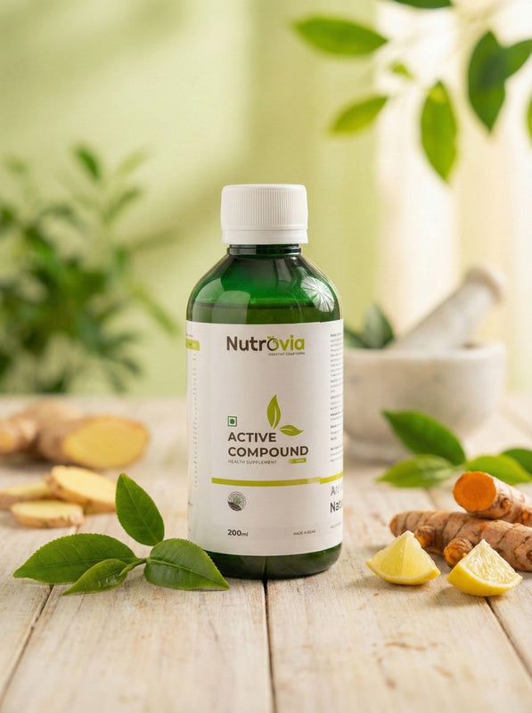 Nutravia Active Compound bottle on a wooden surface with ginger, lemon, and green leaves in the background.
